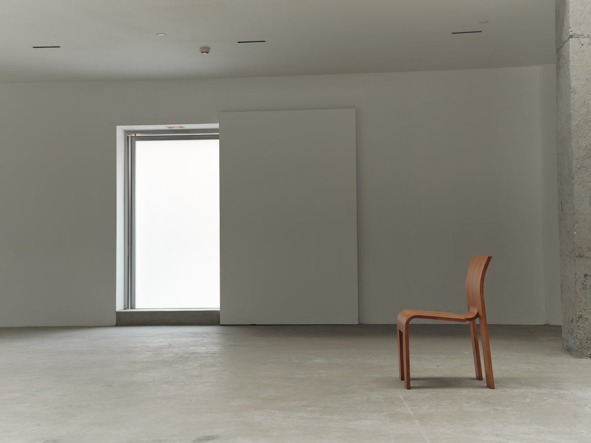 RETRO21 — wooden chair in a concrete studio